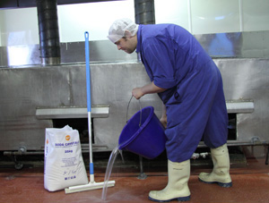 treating greasy floors with sodium carbonate solution