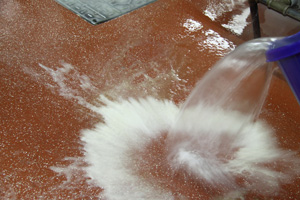 treating greasy floors with sodium carbonate solution